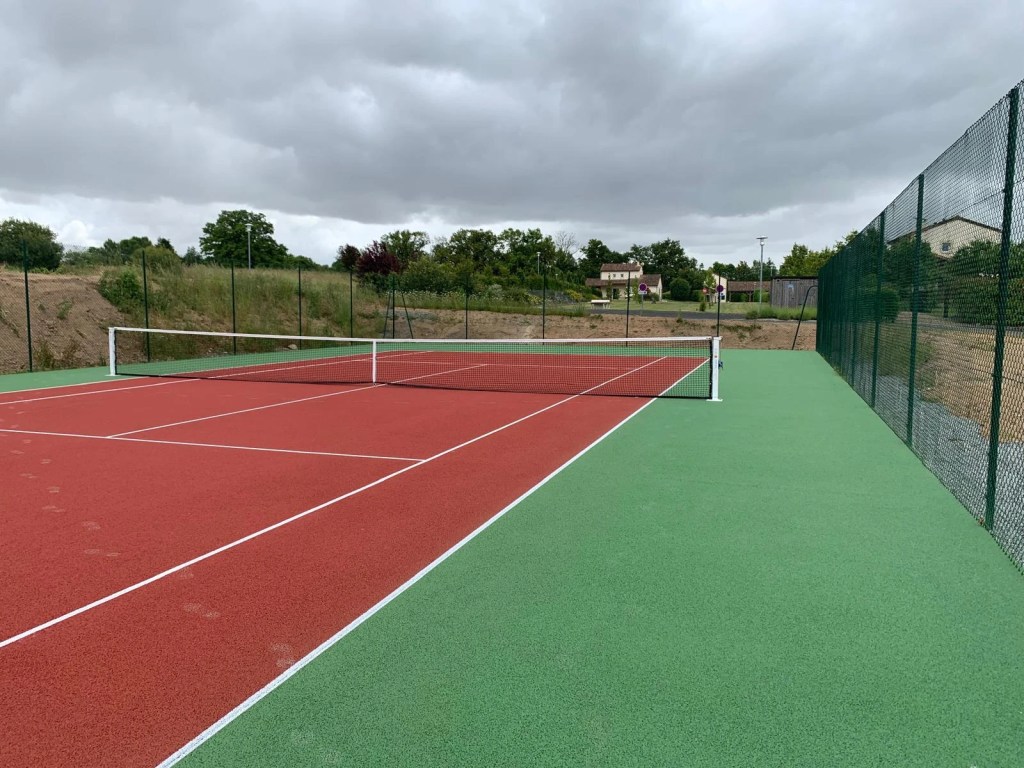 Terrain de tennis en quick avec revêtement rouge et entourages verts – prix terrain tennis quick